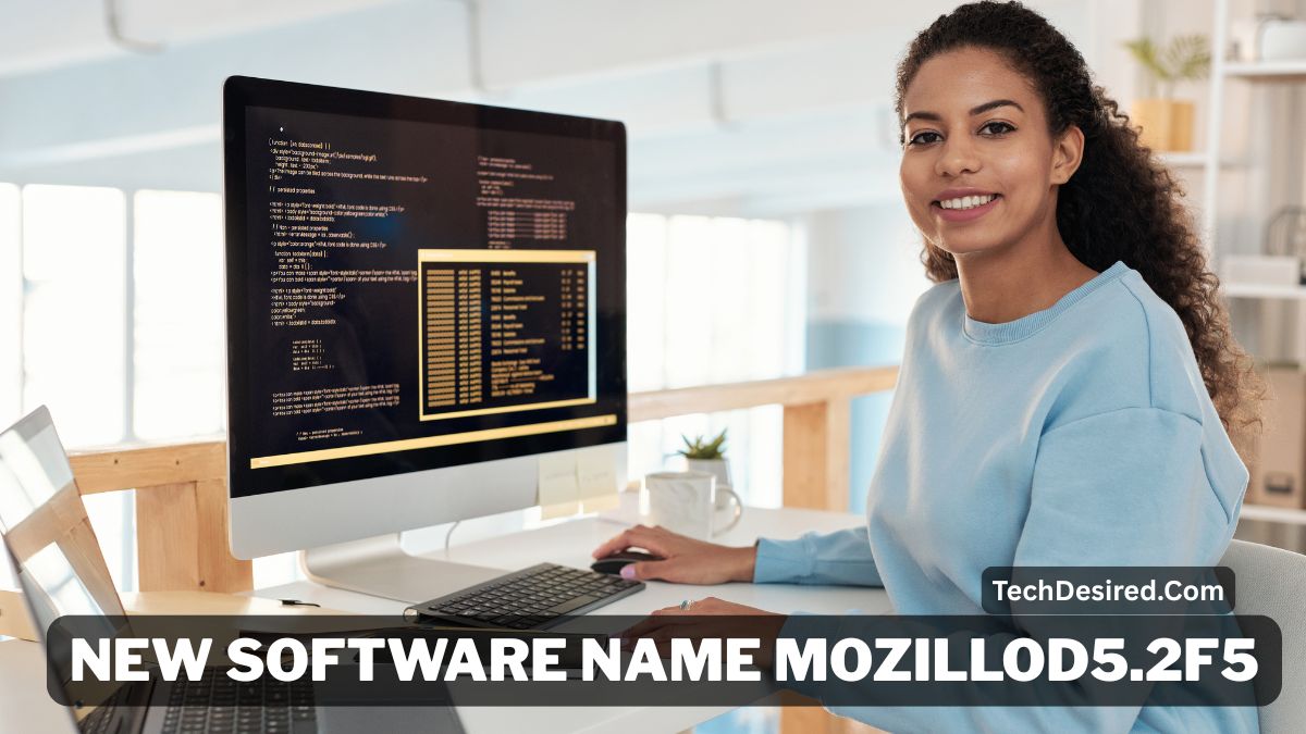 Smiling woman working at a desktop computer in a modern office, with code displayed on the monitor. A banner overlay reads “New Software Name Mozillod5.2F5,” and the TechDesired.com watermark appears on the image.